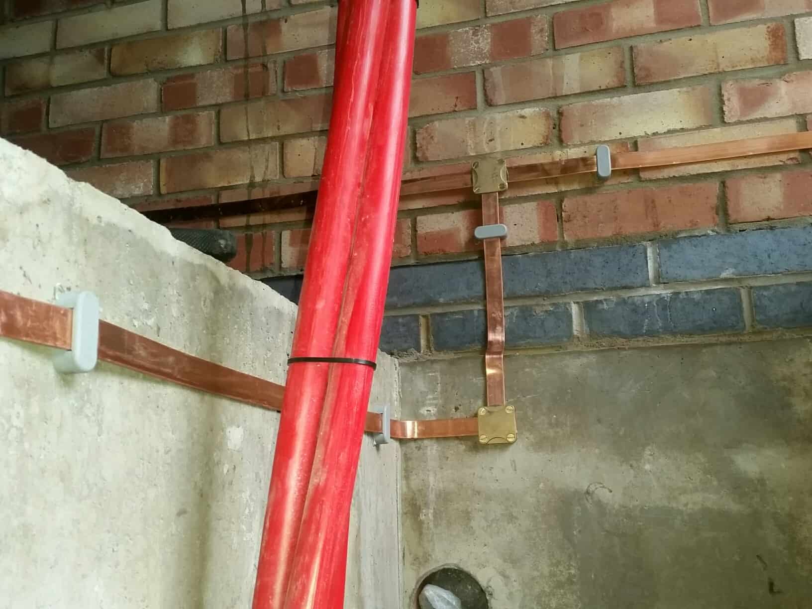 Earthing System Attached to Concrete and Brick Wall